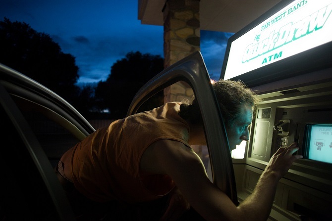 Homem usando um caixa eletrônico